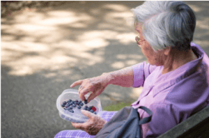 Senior eating blueberries